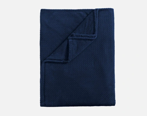 Top view of our Navy Chevron Plush Blanket folded into a tidy square.