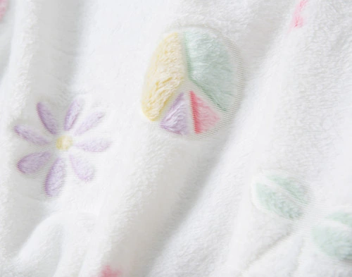 Close-up on the floral and peace sign designs on our Peace & Love in the Dark Fleece Throw.