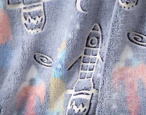 Close-up on the rocket and space-themed designs on our Rocket in the Dark Fleece Throw.