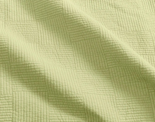 Close-up of the textured patch pattern on our Kenzie Cotton Quilt Set in Stem Green.