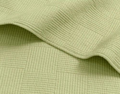 Side view of the edge on our Kenzie Cotton Quilt Set in Stem Green with a slight hem and soft cotton surface.