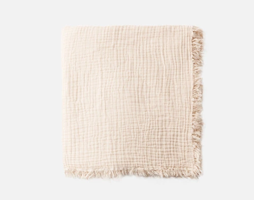 Top view of our Muslin Gauze Throw in Natural folded into a tidy square.