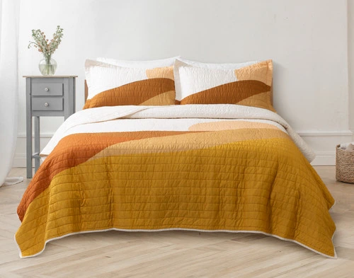 Front view of our Golden Hills Cotton Quilt Set in a light white bedroom.