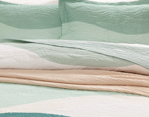 Closer view of the pillows and folded top edge on our Ocean Waves Cotton Quilt Set.