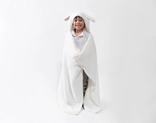 Front view of a school-aged child wearing our Rabbit Hooded Animal Throw in a plain white room.