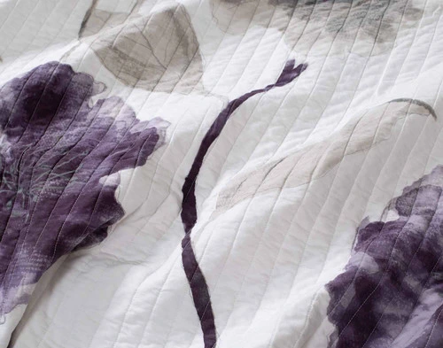 Close-up of the oversized dark violet florals on the surface design of our Nocturne Cotton Quilt Set.