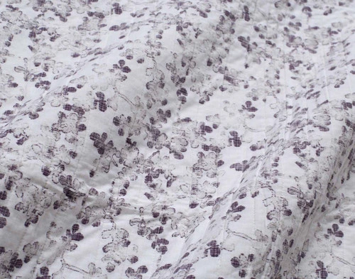 Reverse view of our Nocturne Cotton Quilt Set to show its coordinating distressed leaf print backing.