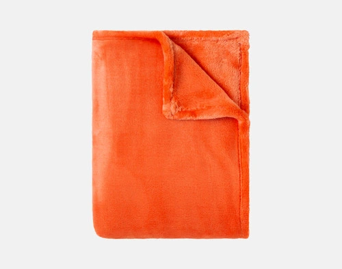 Our Velvet Plush Throw in Bonfire folded neatly into a tidy square.