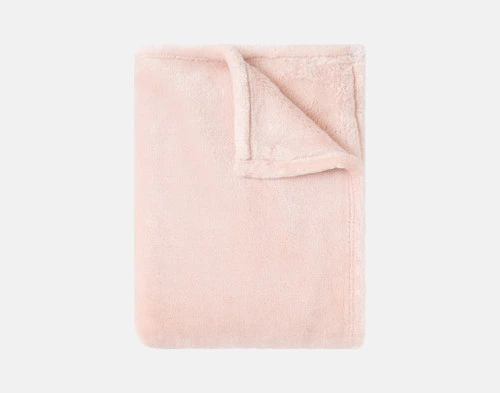 Our Velvet Plush Throw in Powder Pink folded neatly into a tidy square.