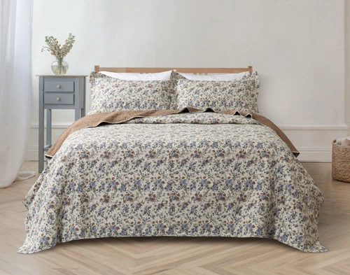 Front view of our Millie Cotton Quilt Set dressed over a queen bed in a simple white bedroom.