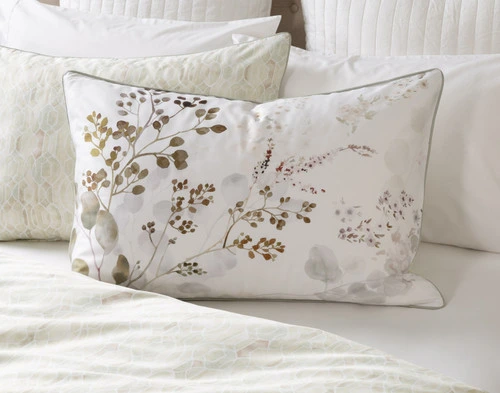 Front view of our Sasha Pillow Sham sitting on a queen bed with coordinating white bedding.