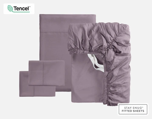 The full contents of our BeechBliss TENCEL™ Modal Sheet Set in Purple Haze sitting against a solid background, including a fitted sheet, flat sheet, and two pillowcases.