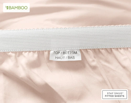 Bottom elastic on our Bamboo Cotton Fitted Sheet in Rosemist to show a tag stating "Top" and "Bottom".