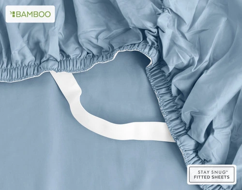 Underside of our Bamboo Cotton Fitted Sheet in Mistral Blue with two hands stretching the snug fit elastic strands around the corner of a mattress.