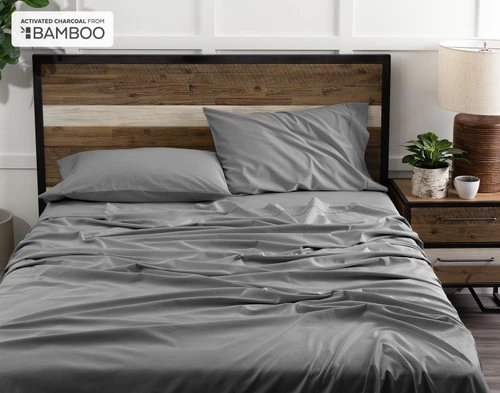 Front view of our Deep Charcoal Bamboo Cotton Sheet Set ruffled and lived-in over a queen bed.