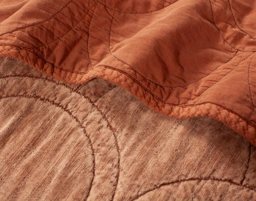 Close-up of a folded edge on our Renae Quilt Set to show its cotton percale backing and cotton blend velvet surface.