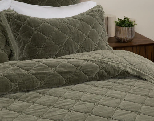 Angled view of our Silas Quilt Set neatly made over a queenbed.