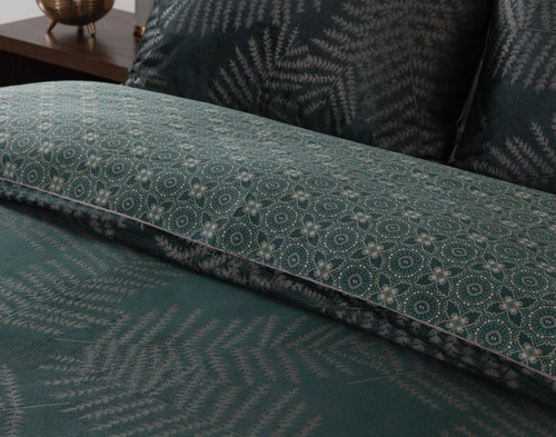 Closer view of our Astra Duvet Cover folded to show its geometric print reverse and velvet surface together.