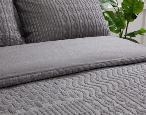 Closer view of the folded edge on our Soren Duvet Cover folded to show its smooth jersey reverse and knit-style jersey surface.