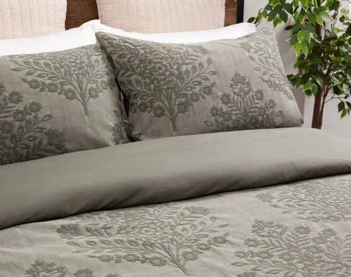 Angled close  view of our Raintree Duvet Cover Set to show its folded duvet cover and pillow  shams.