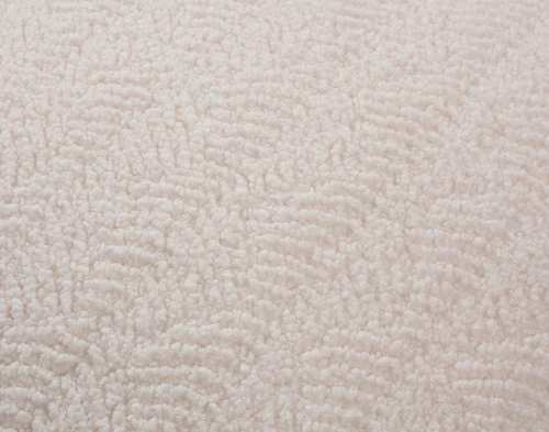 Close-up of the subtle rippling pattern on our Ripple Boucle Lumbar Pillow in Cream.