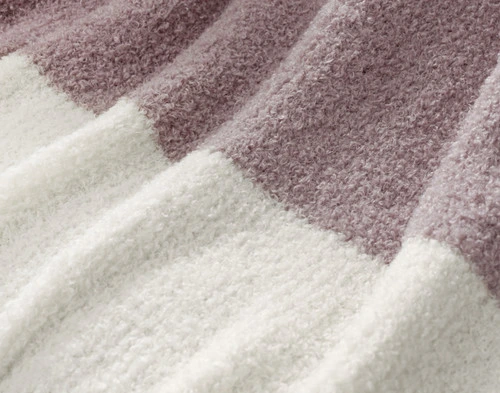 Close-up of the knit surface and alternating colours of our Ash & Cream Wooly Knit Throw.