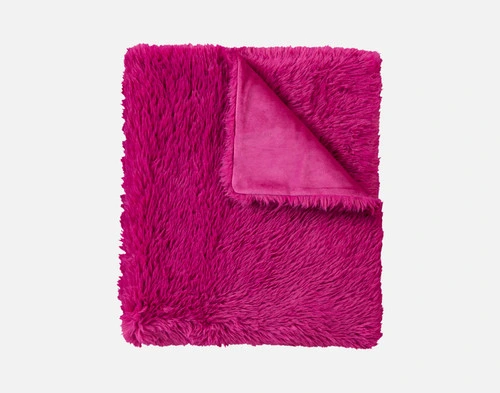 Close-up of the folded corner on our Fuchsia Soft Mink Throw to show its smooth underside and fluffy surface.