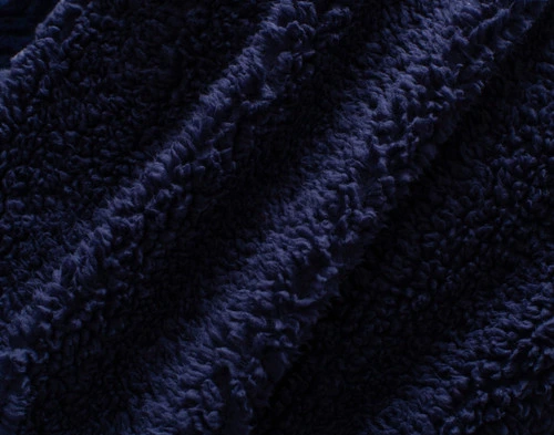 Close-up of the fluffy sherpa backing on our Navy Chevron Etch Throw.