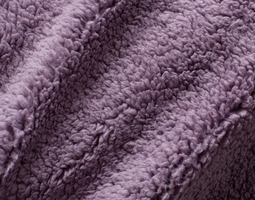 Close-up of the fluffy sherpa backing on our Purple Sage Chevron Etch Throw.