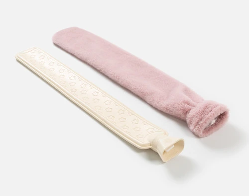 The rubber insert and removable cover of our Pink Faux Fur Lumbar Hot Water Bottle sitting side-by-side.