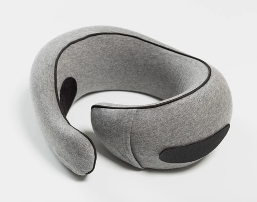 Angled view of our Neck-Hug Travel Pillow sitting on a solid white ground.