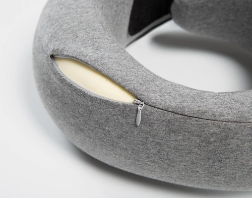 Close-up of the zipper enclosure on our Neck-Hug Travel Pillow, half-open to reveal its memory foam insert .