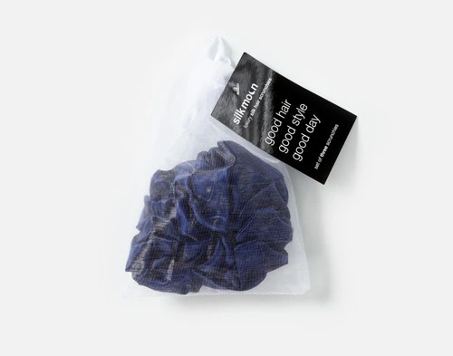 Top view of the mesh bag packaging holding our Navy Mulberry Silk Scrunchie Set.