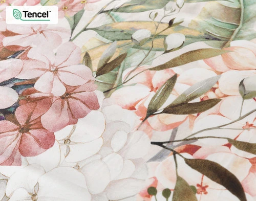 Close up of our Positano Floral Duvet Cover, featuring white and pink flowers and green leaves.