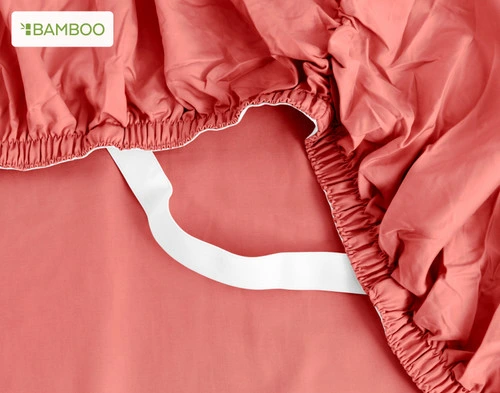 The corner of our Bamboo Cotton Fitted Sheet in Huckleberry, showing the Snug Fit elastic that helps to secure it to your bed.