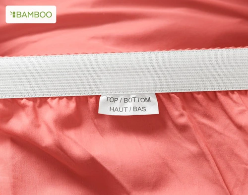 Close up of the Bamboo Cotton Fitted Sheet in Huckleberry Snug Fit elastic for securing the sheet to the bed.