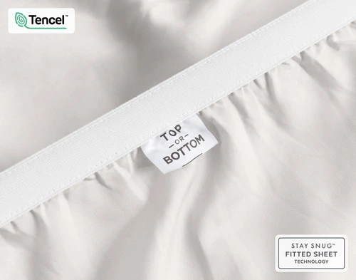 Close-up on the ruffled corner loosely resting on our BeechBliss TENCEL™ Modal Fitted Sheet in Moon.