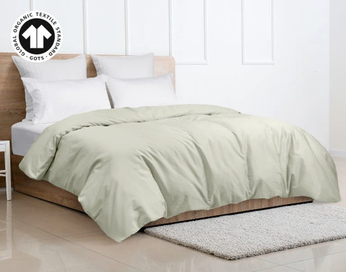 Side view of our Organic Cotton Duvet Cover in Sagebrush Green dressing a queen bed in a simple bedroom.