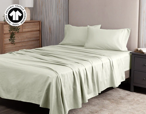 Angled view of our Organic Cotton Sheet Set in Sagebrush dressed over a short queen bed.