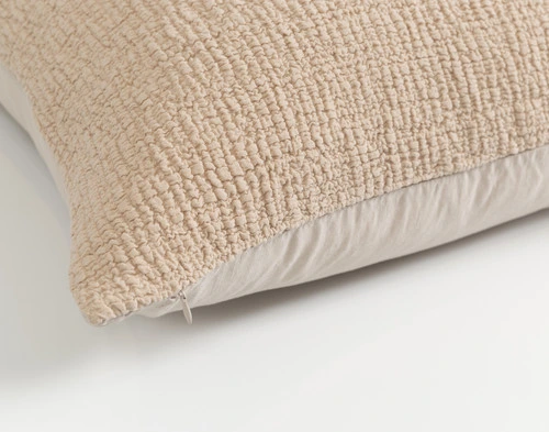 Angled view of the edge of our Crinkle Euro Sham in Sand with the front side up.