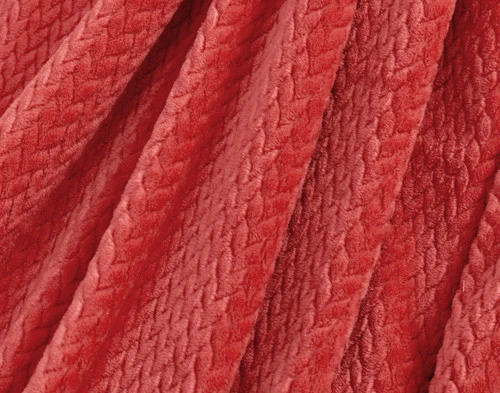 Close-up on the ruffled fabric on our Chevron Plush Throw in Strawberry to show its soft surface.