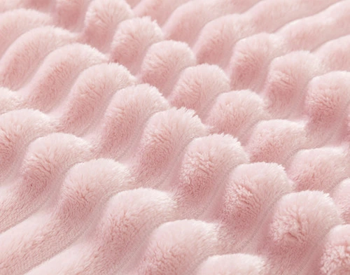 Close-up on the textural ribbed lines on our ______ Ribbed Plush Blanket.