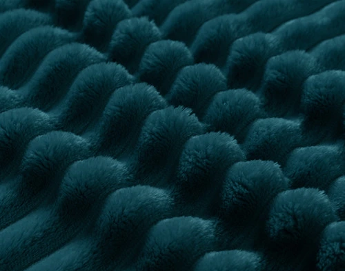 Close-up on the textural ribbed lines on our ______ Ribbed Plush Blanket.