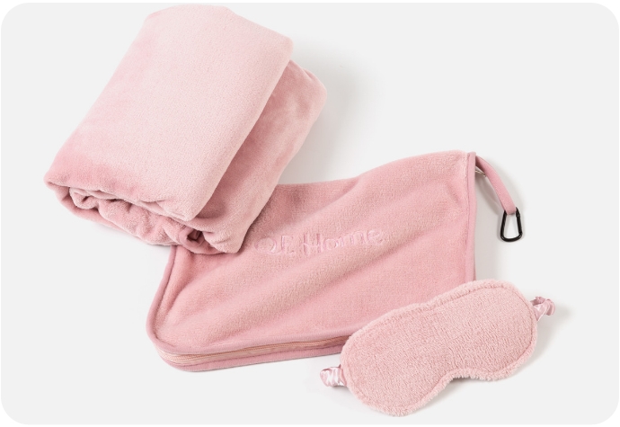 Our Travel Mate Blanket and Sleep Mask Set in Blush Pink shown on a white background.