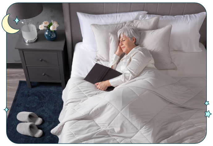 Top view of a woman sleeping comfortably in a light bed under our Cool Touch Blanket in Grey.