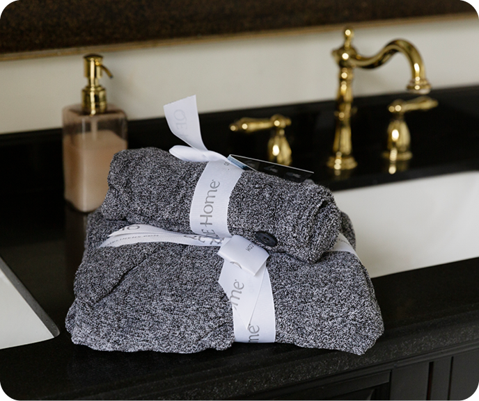 Our Charcoal Infused Cotton Towels placed on a bathroom counter top.
